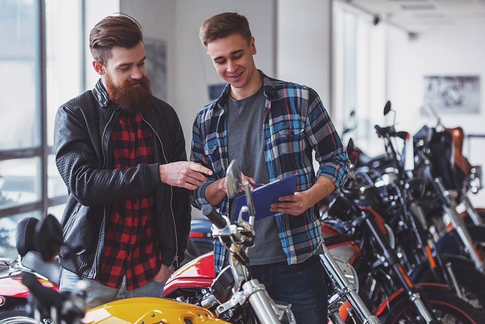 Men in motorbike shop